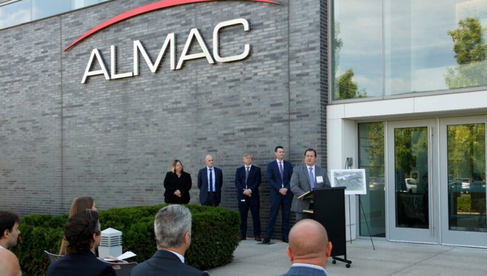 man at podium outside building