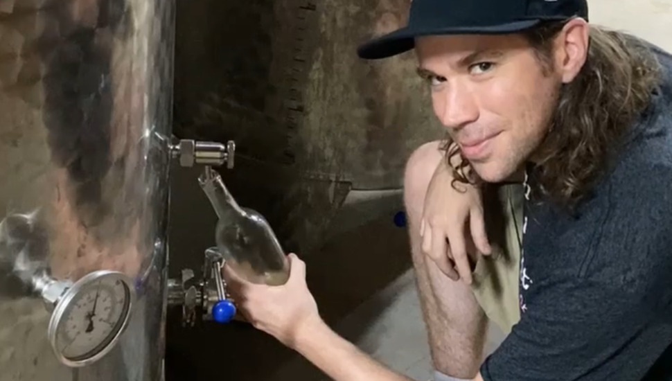 man holding empty bottle
