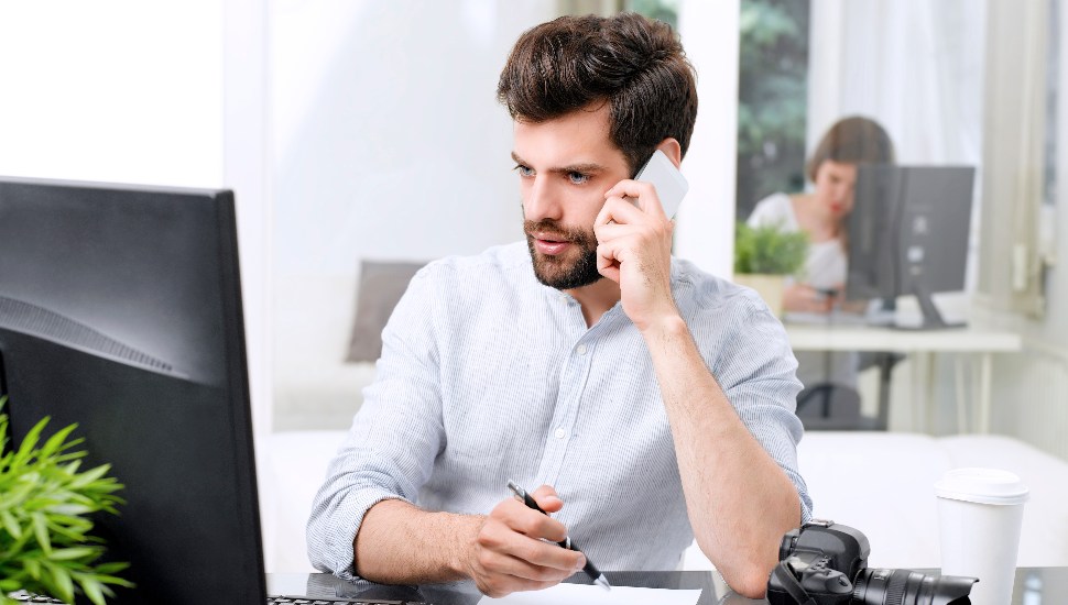 man with beard on phone