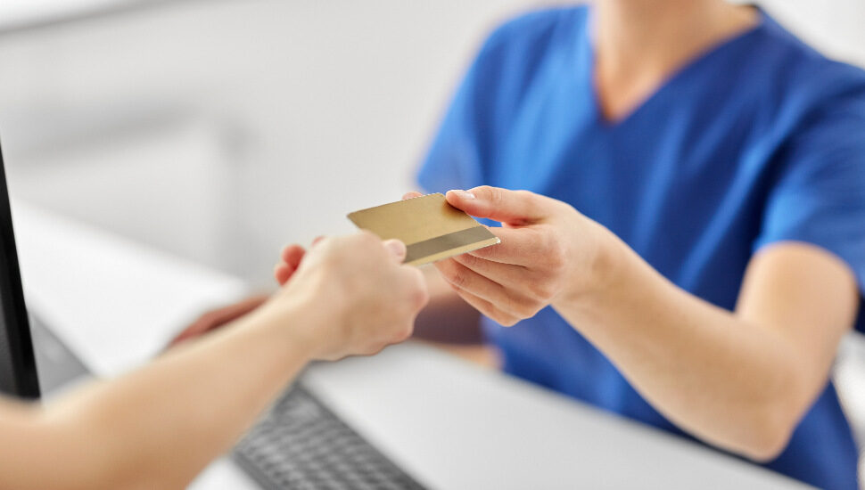 patient handing over a credit card