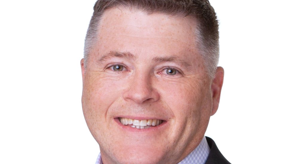 smiling man with brush haircut