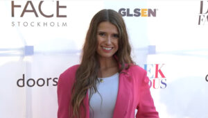 smiling woman in pink blazer