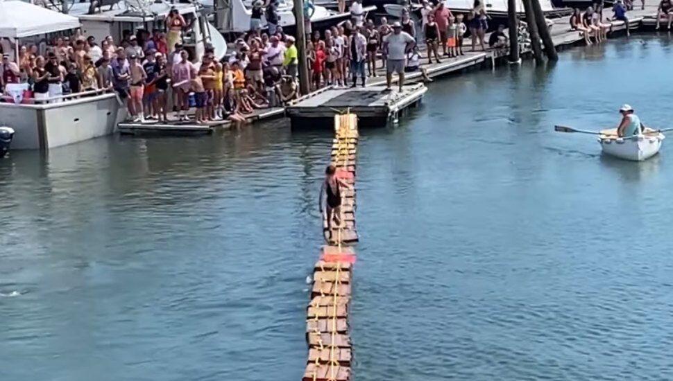 girl running across crates floating on water