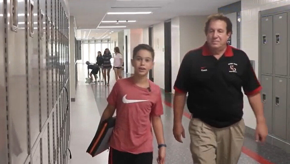 adult and child in school hallway