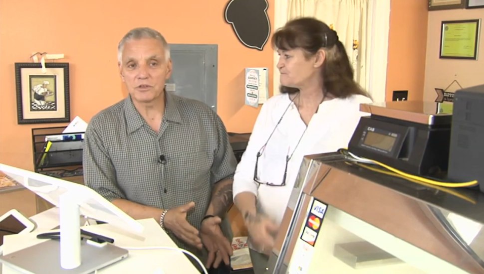 man and woman behind counter