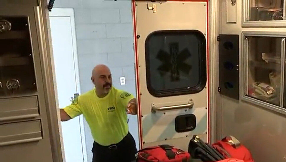 man in yellow shirt shutting vehicle doors