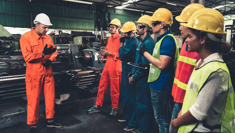people in hard hats talking