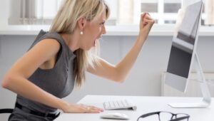 woman yelling at her computer screen