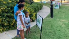 family reading signs