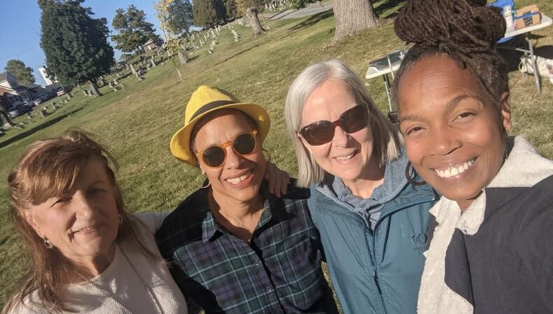 four smiling women outdoors