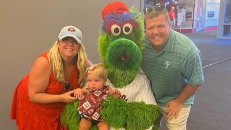 baby held by green mascot for 2022 World Series