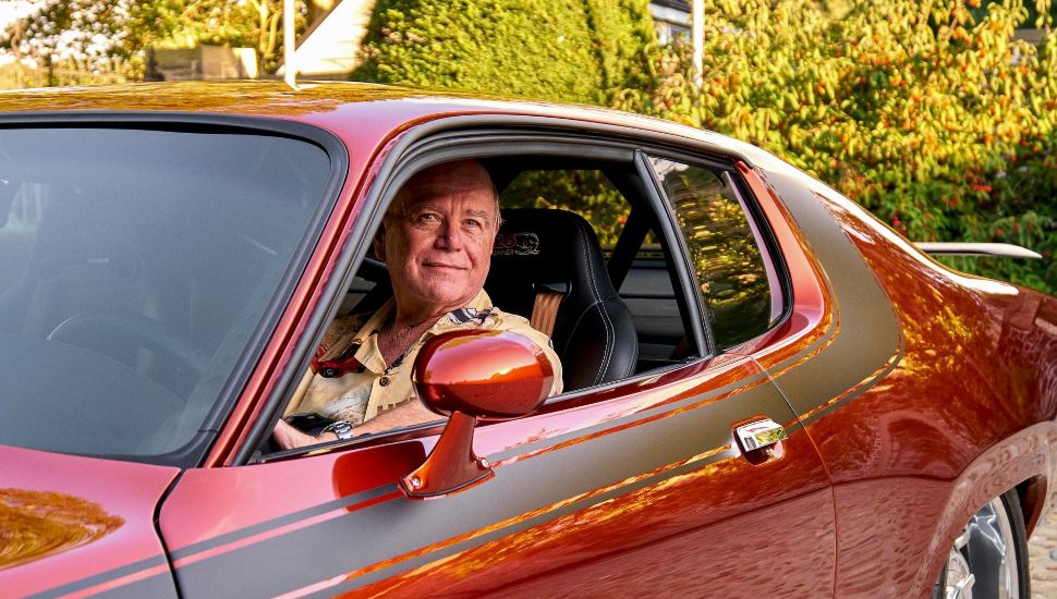 man in a red car