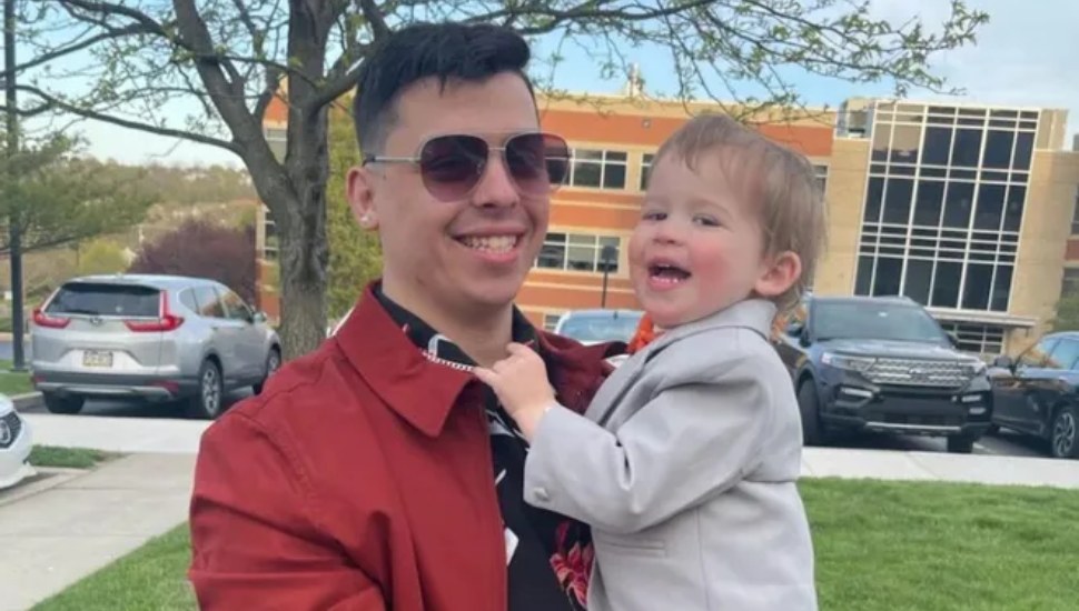 smiling man holding child