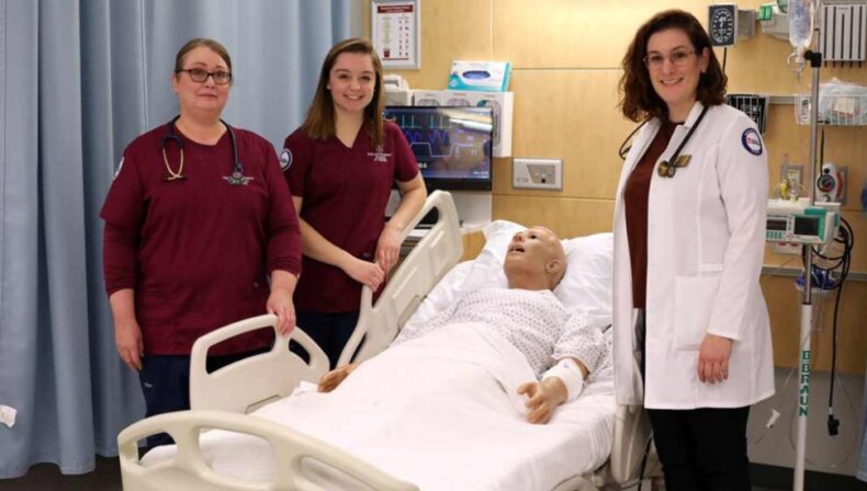 three women around a hospital bed