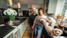 couple in a kitchen with dogs