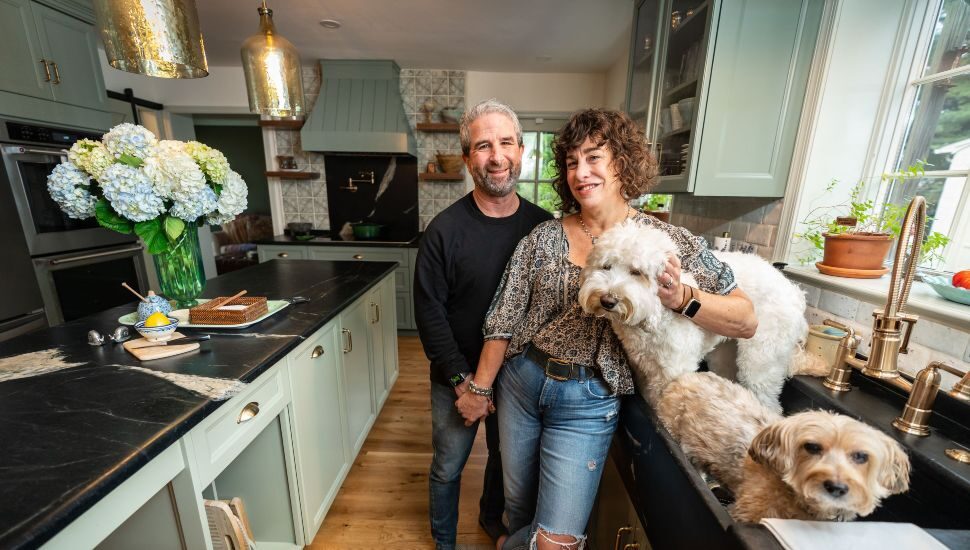 couple in a kitchen with dogs