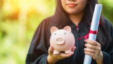 graduates holding piggy bank financial aid