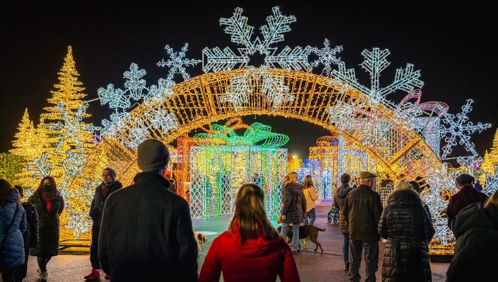 People walking through Tinseltown light display