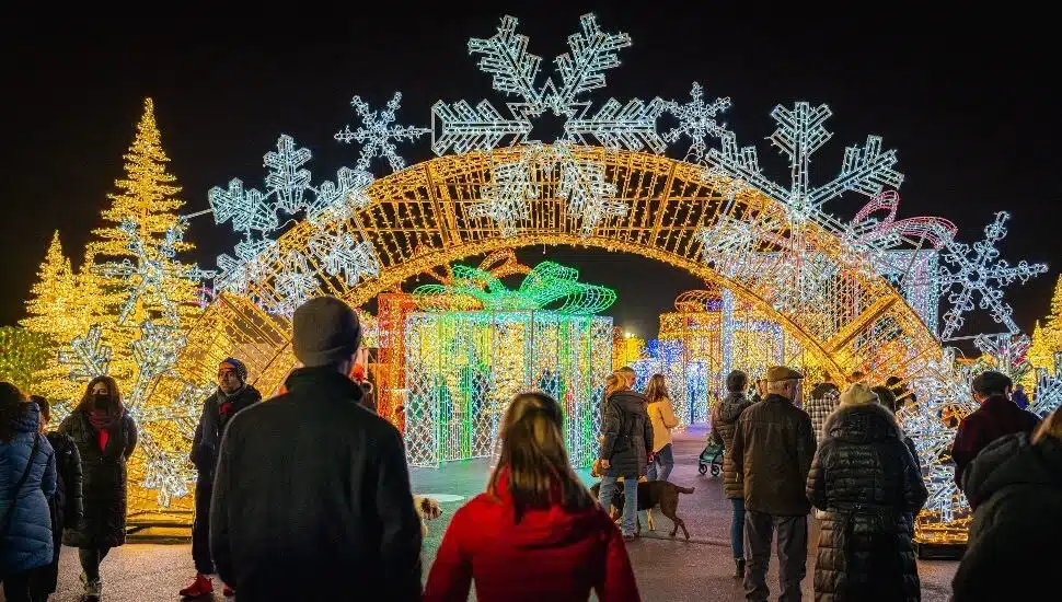 People walking through Tinseltown light display