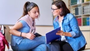 A girl talks with a counselor
