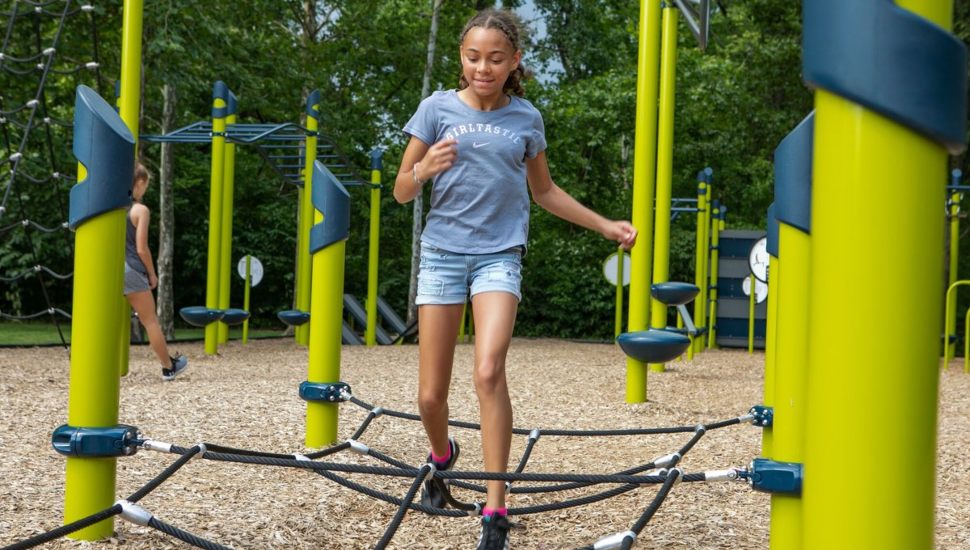 A girl running through a fitness course