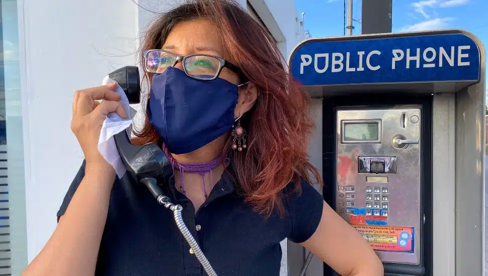 Woman using a pay phones