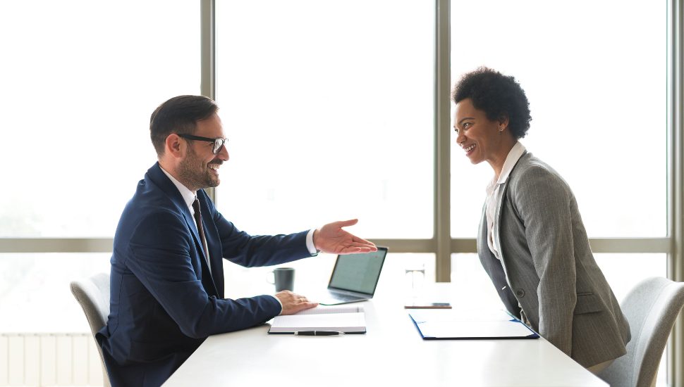 Senior manager welcoming the job candidate to the interview.