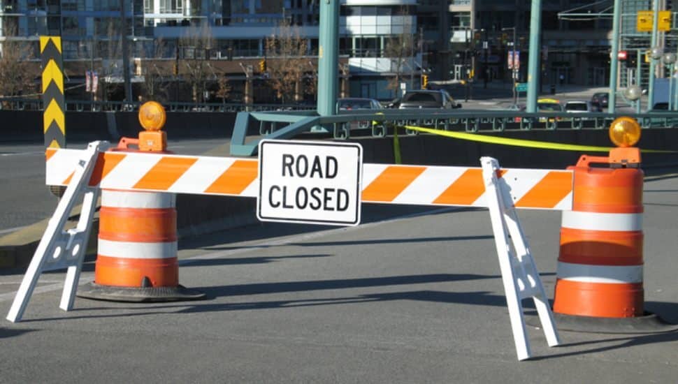 orange-yellow sign in road