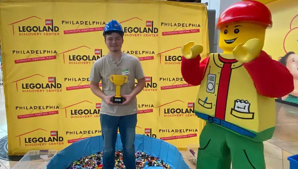 teen with trophy and mascot