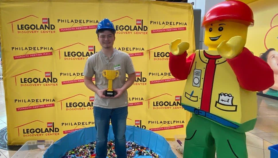 teen with trophy and mascot