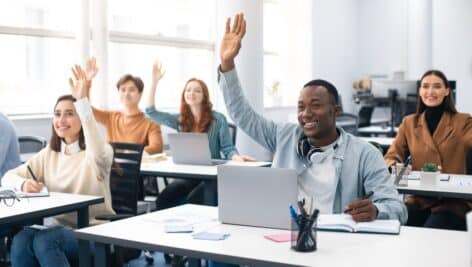 students adult in college raising hands job posting for part-time training coordinator