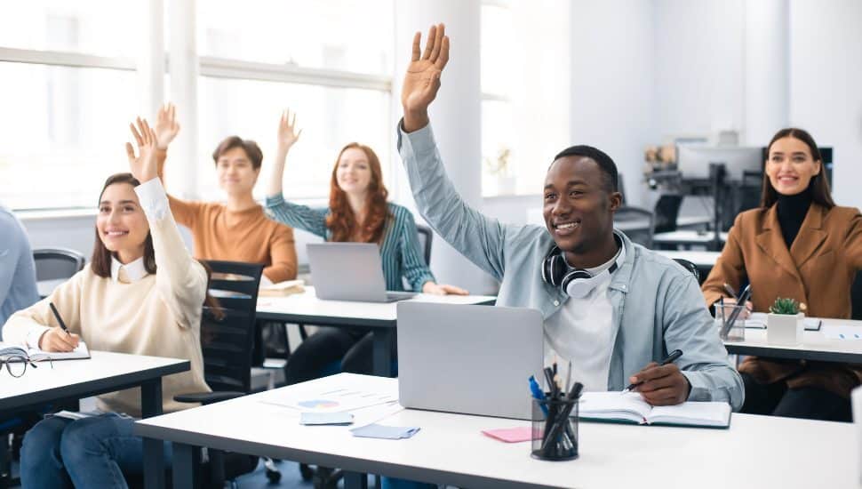 students adult in college raising hands job posting for part-time training coordinator