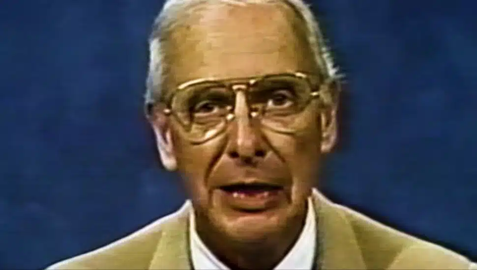 Bill Schonely, man in coat and tie
