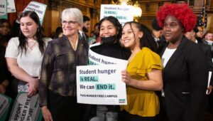 senator comitta and group of people around her with signs for hunger-free campus