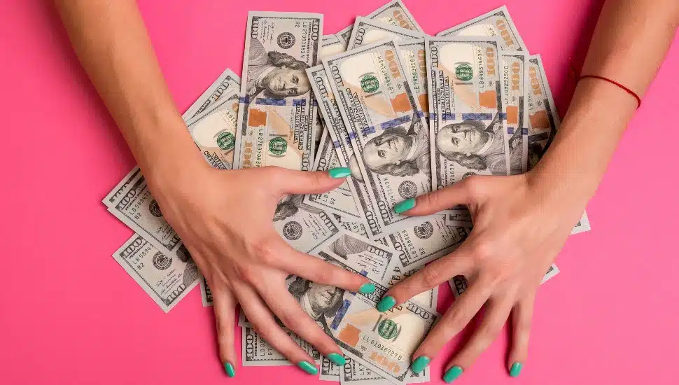 Woman hoarding 100 dollar bills