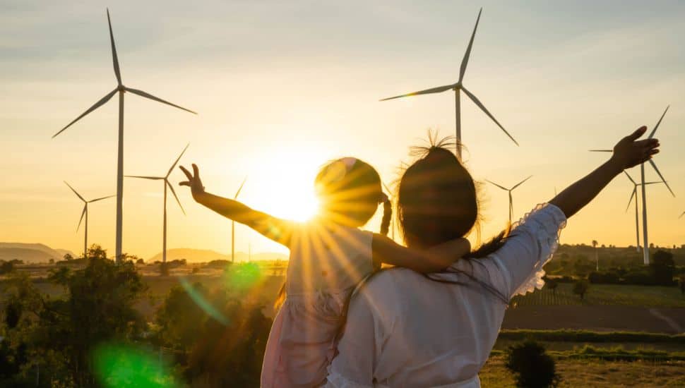 Wind turbines are alternative electricity sources, the concept of sustainable resources, People in the community with wind generators turbines, Renewable energy.