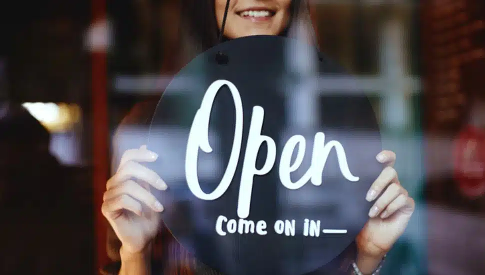 woman with sign in a new restaurant