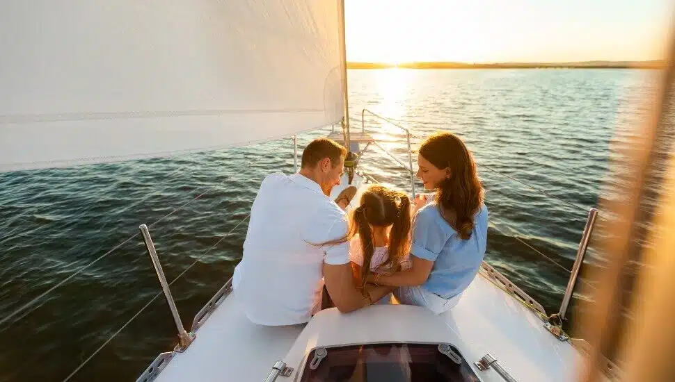 Couple on a sail boat with their young daughter