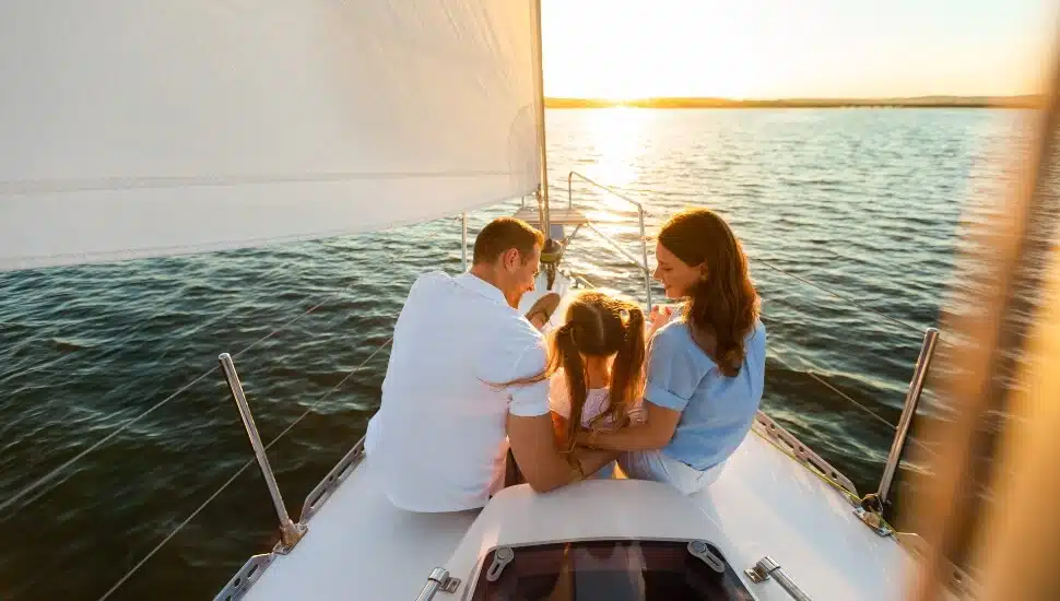 Couple on a sail boat with their young daughter