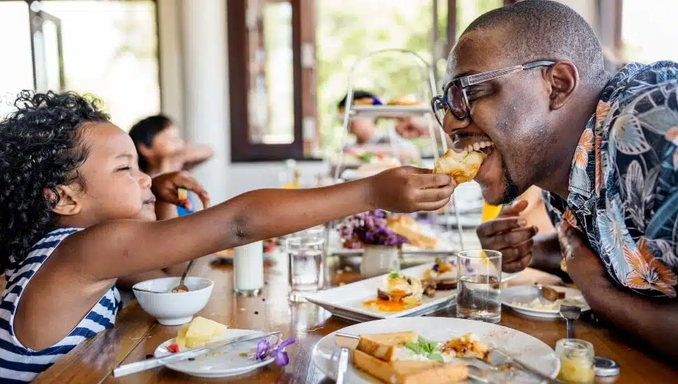 Playful father at breakfast