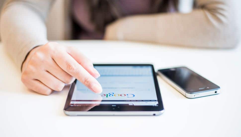 woman typing in Google on phone