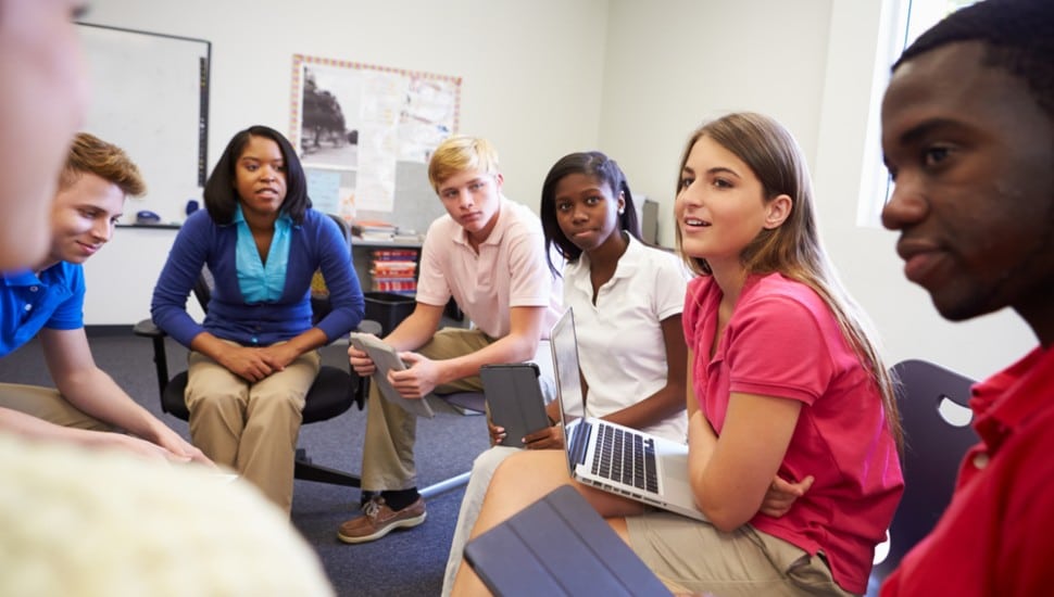 Students in a group talking and sharing time together