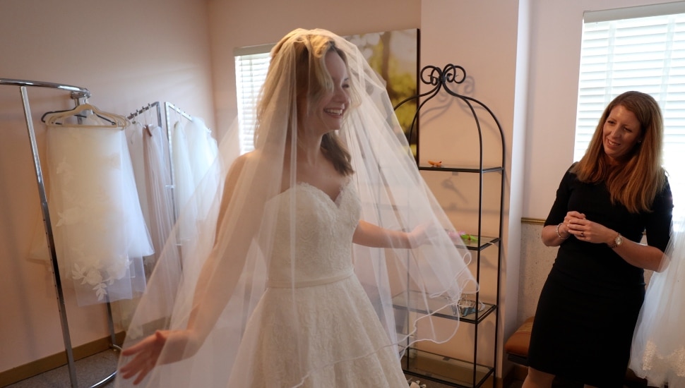 Nicole Bridal owner works with a bride.