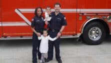 Jennifer Kingsberry, with her husband and two young daughters in front of fire truck