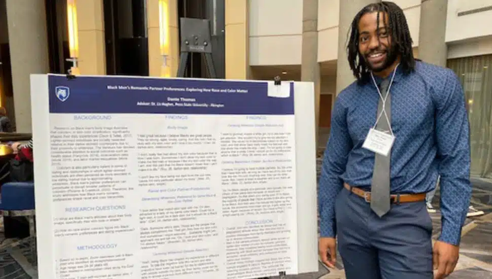 Dante Thomas in front of data board