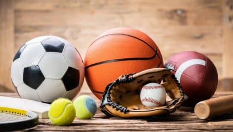 Sports equipment including soccer balls and basketballs.