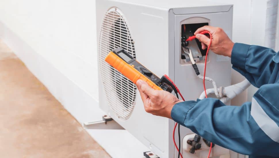 Air conditioner technician checking air conditioner operation
