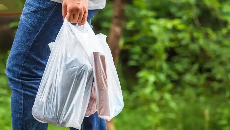 Man carrying single Use Plastic Bags