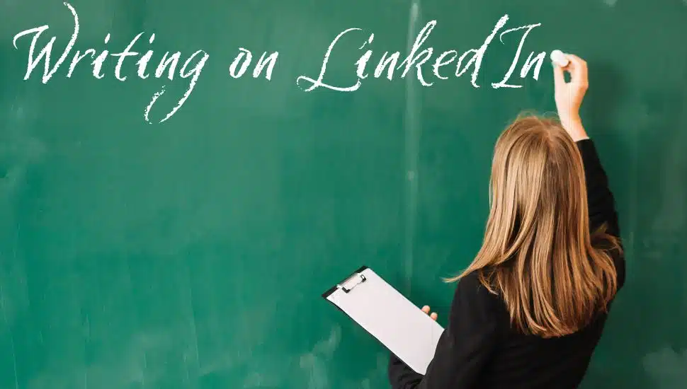 girl writing on a green chalkboard