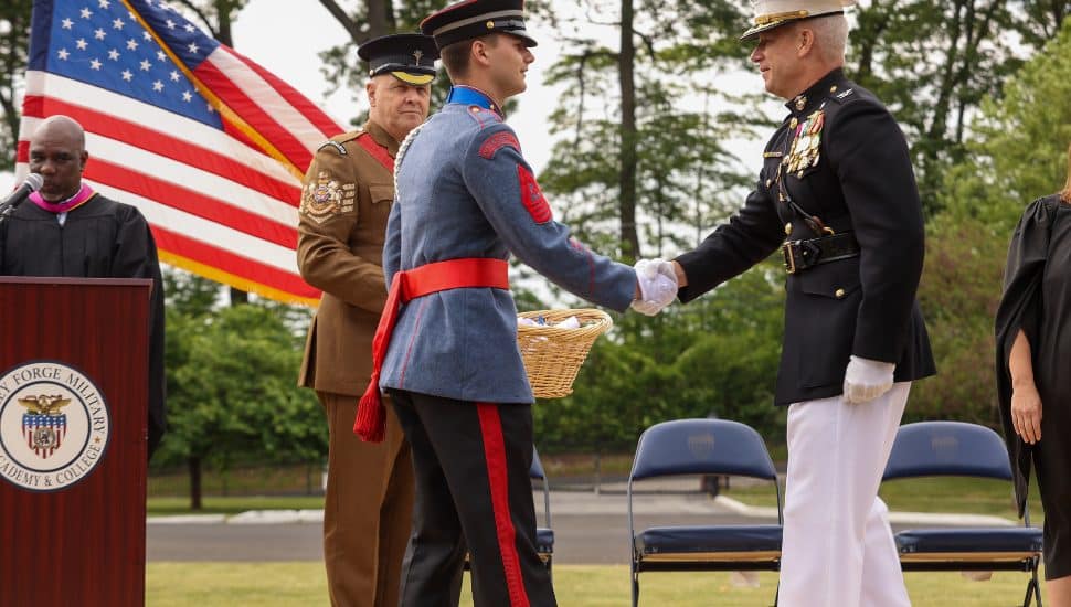 VFMA president, Col. Stuart B. Helgeson, USMCR (Ret) congratulates Cadet Landon Lewis on earning his diploma.